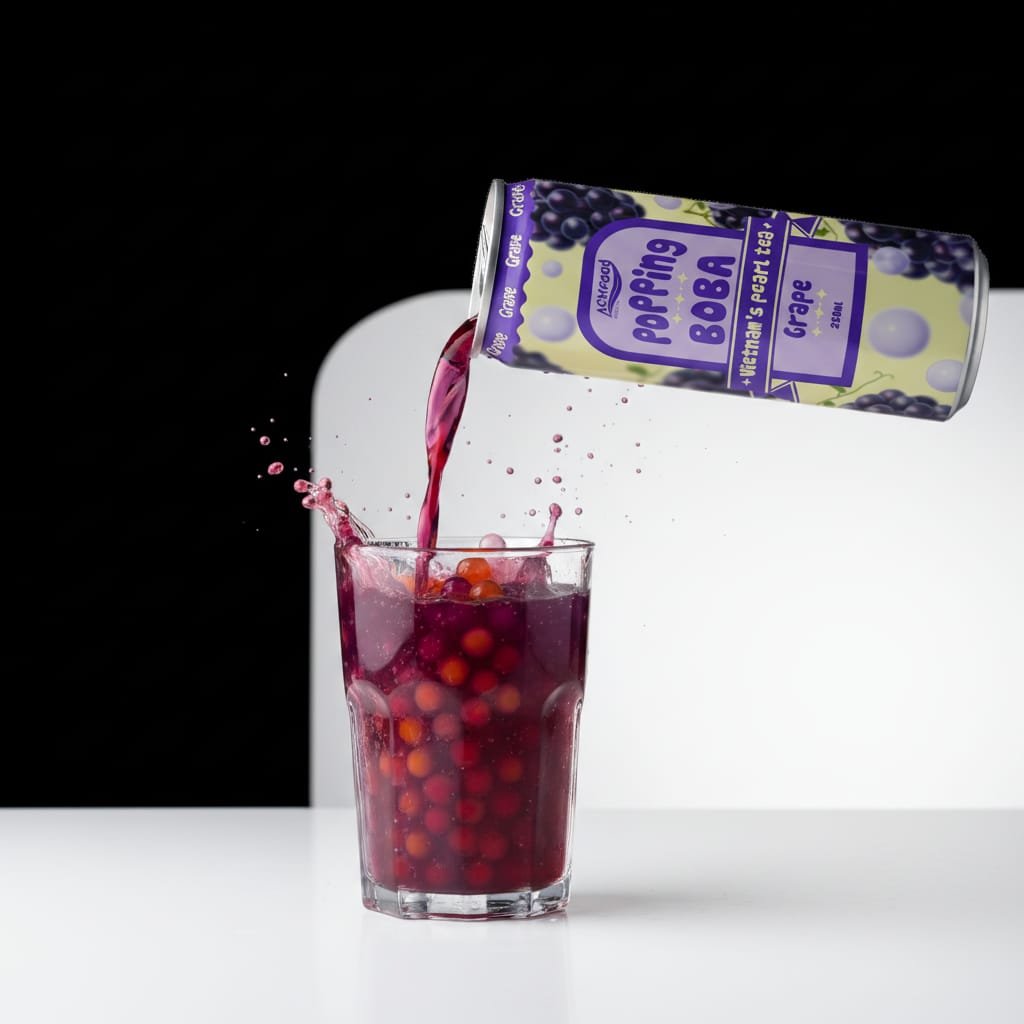 Closeup macro shot of ACM grape bubble tea being poured into a glass showing the purple liquid with visible popping boba